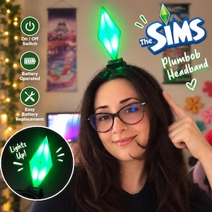 May include: A The Sims Plumbob headband featuring a green, diamond-shaped light-up topper. The product includes an on/off switch, is battery operated, and allows for easy battery replacement. The text on the image reads The Sims Plumbob Headband.