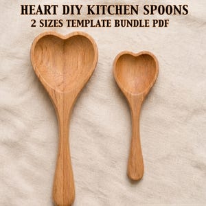 May include: Two wooden heart-shaped kitchen spoons. The spoons are made of light-colored wood and have a smooth finish. The text at the top of the image reads "HEART DIY KITCHEN SPOONS 2 SIZES TEMPLATE BUNDLE PDF".