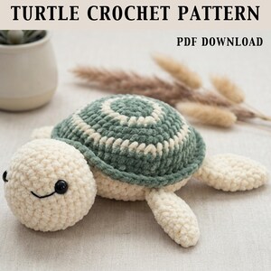 May include: A crocheted turtle pattern with a green and cream shell, cream-colored head and limbs, and black eyes. The text "TURTLE CROCHET PATTERN" and "PDF DOWNLOAD" are at the top of the image. The turtle has a smiling face.