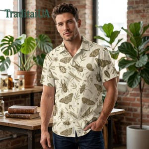May include: Cream-colored short-sleeved button-down shirt featuring a repeating pattern of various insects, butterflies, and botanical elements in shades of brown. The shirt has a classic collar and a relaxed fit, suitable for casual wear.