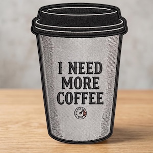 May include: A black and silver embroidered patch shaped like a disposable coffee cup with a lid. The center features the black text I NEED MORE COFFEE above a small circular gauge icon with a needle pointing toward the red zone on the right.