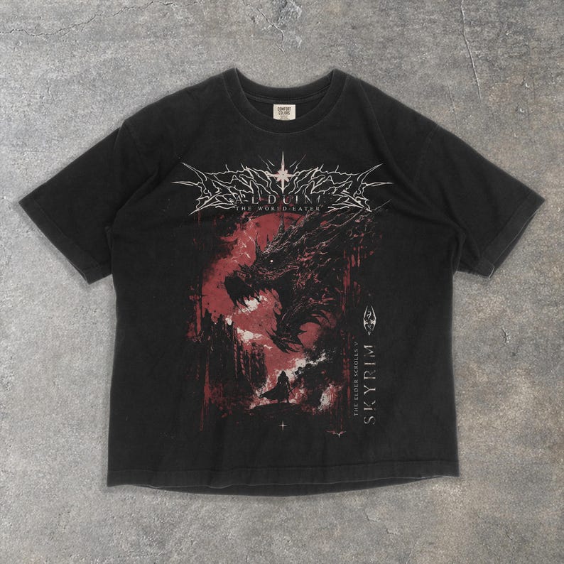 May include: Black t-shirt with a red and black dragon graphic, the text reads "Alduin The World Eater" and "The Elder Scrolls V Skyrim". The design is centered on the front of the shirt.