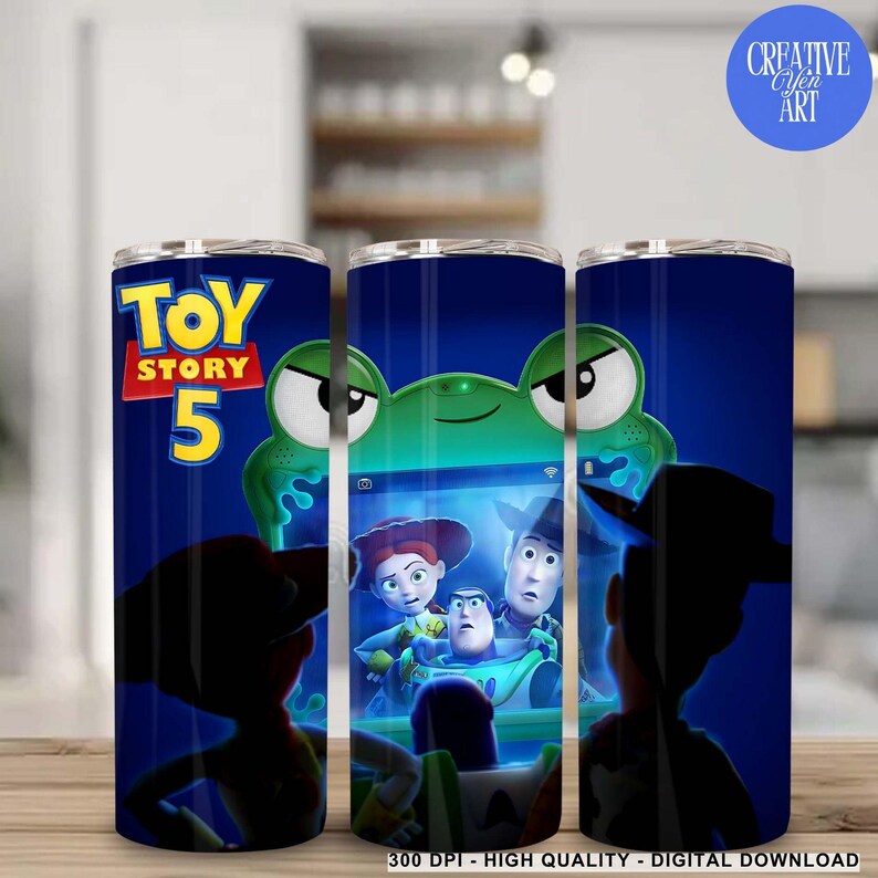 May include: A cylindrical tumbler featuring a dark blue background with the Toy Story 5 logo in yellow and red. The design includes a green alien character and a screen displaying characters from the movie, including a cowboy and a space ranger.