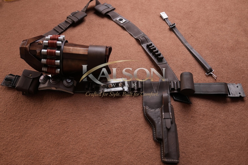May include: A brown leather utility belt with a holster, ammunition storage, and various pouches. The belt features a shoulder strap and is designed for carrying equipment. The text "KALSON" is visible.