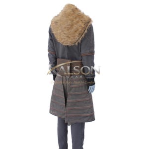 May include: A gray coat with a brown fur collar and brown accents. The coat has a belt and a skirt-like lower section with horizontal stitching. The text "KALSON WEAR" is visible on the coat.