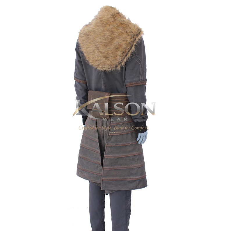 May include: A gray coat with a brown fur collar and brown accents. The coat has a belt and a skirt-like lower section with horizontal stitching. The text "KALSON WEAR" is visible on the coat.