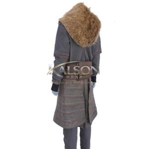 May include: A gray costume with a faux fur hood and brown leather accents. The costume includes a long coat, a belt with a pouch, and a skirt-like bottom. The text "KALSON WEAR" is visible on the belt.