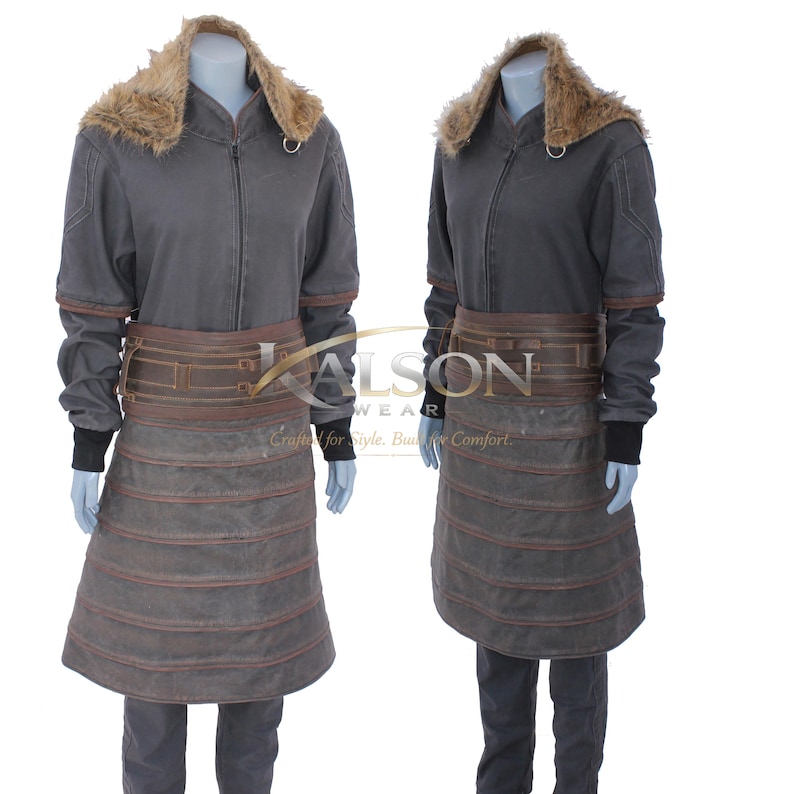 May include: A gray jacket with a faux fur collar and a brown leather belt. The jacket has a zipper closure and black cuffs. The lower portion of the jacket has a layered, apron-like design. The image shows two mannequins wearing the same outfit.