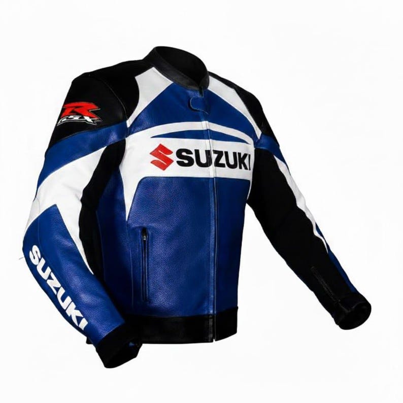 May include: A blue, white, and black leather motorcycle jacket with the Suzuki logo prominently displayed. The jacket features a stand-up collar, zippered front, and the Suzuki name on the sleeves. The jacket is designed for motorcycle riding.