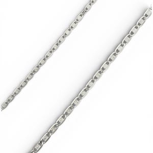 May include: A silver-colored chain necklace with a repeating oval and diamond-shaped pattern. The chain is displayed against a white background, highlighting its reflective surface and intricate design. The necklace appears to be made of metal.