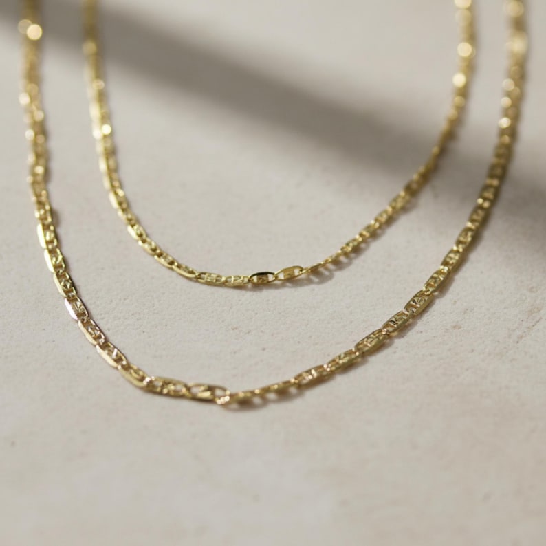14K solid gold Valentino chain necklace close-up on neutral background, delicate faceted gold chain necklace