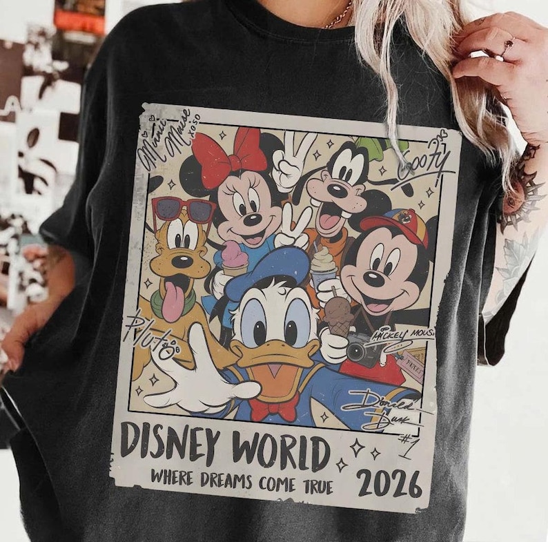 May include: Black t-shirt featuring a vintage-style graphic of Disney characters including Mickey Mouse, Minnie Mouse, Donald Duck, Goofy, and Pluto. The graphic reads "Disney World" and "Where Dreams Come True 2026".