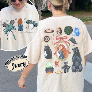 May include: Ivory-colored t-shirt featuring a design with cartoon illustrations. The front has a graphic with text, while the back showcases various themed images, including a bear, horse, and a character in a frame. The shirt is part of the "Comfort Colors" collection.