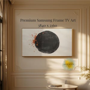 Pode incluir: Uma obra de arte emoldurada para uma TV Samsung Frame. A obra apresenta um grande círculo preto com respingos de tinta laranja sobre um fundo branco. O texto "Premium Samsung Frame TV Art" e "3840 x 2160" são exibidos.