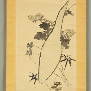 May include: An ink wash painting on a cream-colored background. The artwork depicts a large, abstract shape with black lines, and several sprigs of flowers and leaves. The flowers are white with yellow centers. The painting is framed with a yellow border.