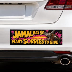 Könnte beinhalten: Ein rechteckiger Autoaufkleber auf einem weißen Fahrzeug mit schwarzem Hintergrund und gelbem Text, der JAMAL HAS SO MANY SORRIES TO GIVE lautet. Das Design zeigt einen mechanischen Hai, der Feuer speit, rosa Sternchen und kleine Totenköpfe.