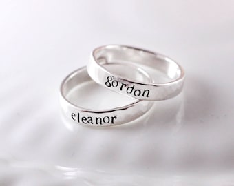 May include: Two silver rings with the names "Eleanor" and "Gordon" engraved on them.
