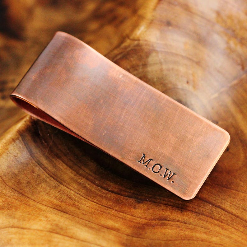 May include: A copper money clip with the initials "M.C.W." engraved on the front.