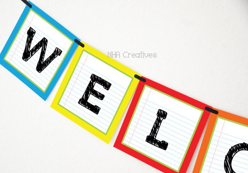 May include: A colourful welcome banner with each letter on a separate card. The letters are written in black marker on white paper with blue lines. The cards are blue, yellow, red, orange, and green.