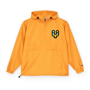 May include: An orange Champion anorak jacket with a hood and a front pocket. The jacket features a small, colorful logo on the left chest. The jacket has a drawstring at the hem and a zipper at the neck.