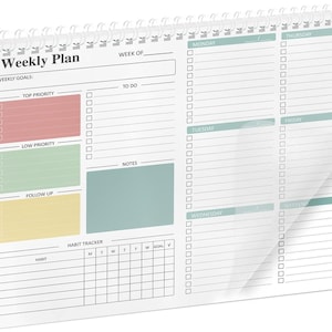 May include: A white spiral-bound weekly planner with a clear plastic cover. The planner features sections for weekly goals, to-do lists, and a habit tracker. Color-coded sections include red, green, and yellow for priority levels. The text "Weekly Plan" is printed at the top.