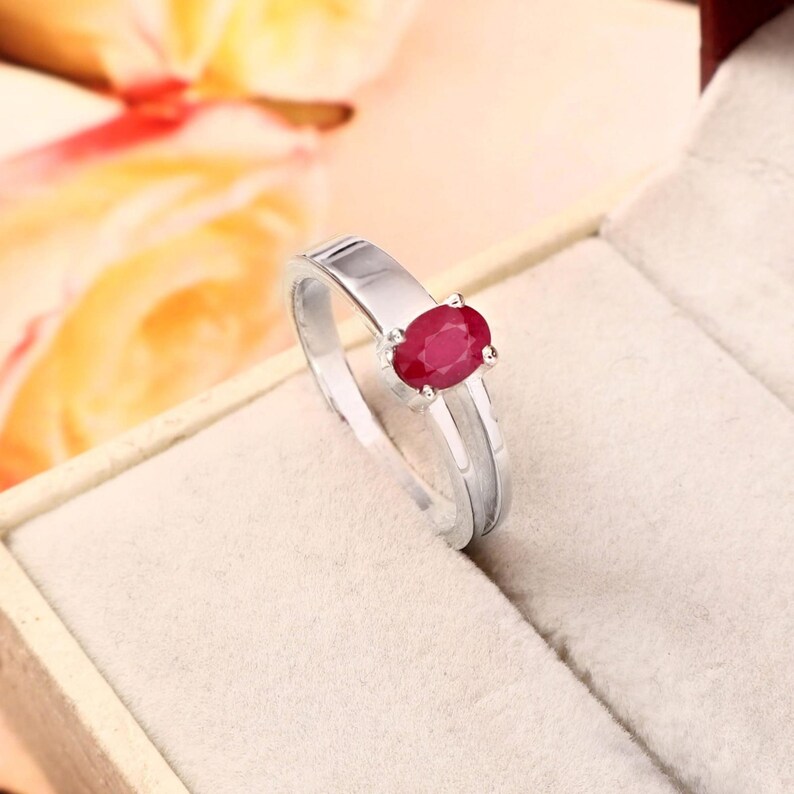 Detailed natural ruby ring feature image showing the key gemstone specifications: 0.69 ct ruby weight and elegant oval shape. The pinkish red natural ruby is presented prominently so buyers can clearly understand the gemstone profile and proportions before purchasing. A useful product detail image for an oval ruby ring, natural ruby jewelry, July birthstone ring, red gemstone ring, ruby gift for her, anniversary jewelry, birthday gemstone gift and elegant natural stone ring for women.