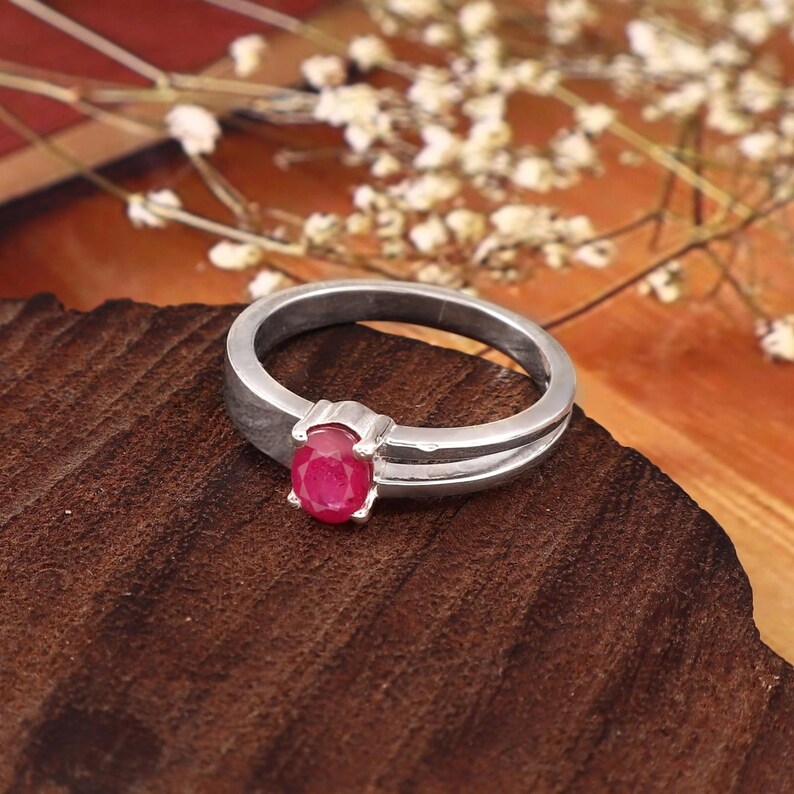 Side angle of the natural oval ruby ring showing the gemstone profile, prong setting, polished band and overall ring construction. This close product view gives buyers a clearer understanding of how the 0.69 ct pinkish red ruby sits within the setting and how the ring looks from another angle. A detailed view for shoppers considering a natural ruby ring, oval gemstone ring, July birthstone jewelry, ruby promise ring, anniversary gift for her or an elegant everyday gemstone ring.