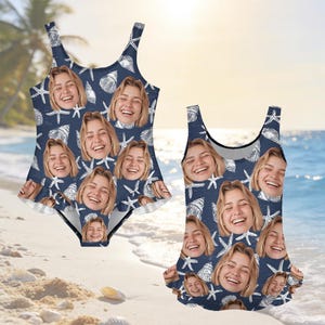 May include: Two matching swimsuits. The swimsuits are navy blue with a pattern of white seashells, starfish, and smiling faces. One-piece swimsuit has a ruffled skirt. The other is a tank-style swimsuit.