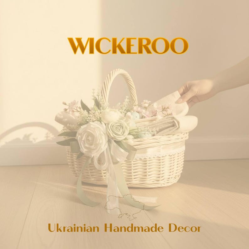 May include: A white wicker basket filled with fabric and decorated with white and pink flowers and a green ribbon. The text "WICKEROO" is above the basket, and "Ukrainian Handmade Decor" is below.
