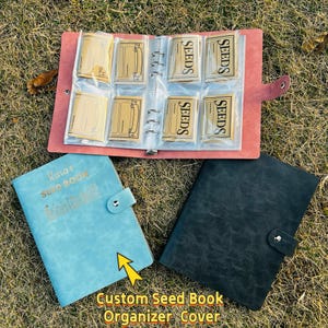 May include: A seed book organizer with a light blue cover, a black cover, and a pink seed packet holder. The light blue book has the text "Kara's Seed Book". The pink organizer holds seed packets. The text "Custom Seed Book Organizer Cover" is at the bottom.