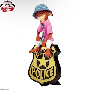 May include: A figurine of Nick Wilde from Zootopia, wearing a pink shirt, blue tie, and a blue hat. He is sitting on a Zootopia Police badge with a gold star and the word "POLICE".
