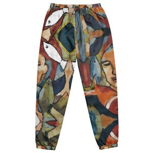 May include: Abstract art sweatpants with an elastic waistband. The pants feature a colorful design with fish, faces, and geometric shapes in shades of blue, red, orange, and white. The artwork is reminiscent of a watercolor painting.