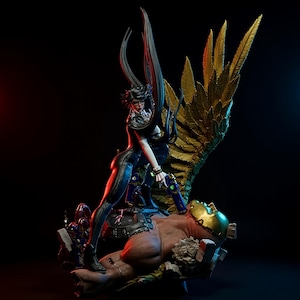 May include: A detailed statue of a woman in a black outfit, holding a gun, standing over a fallen figure. The statue features large golden wings and intricate details, set against a dark background with red and blue lighting.