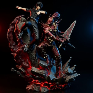 May include: A detailed figurine showing a battle scene. One figure is in red armour with a sword, the other in a black outfit, mid-jump. The base is a rocky landscape with red glowing accents.