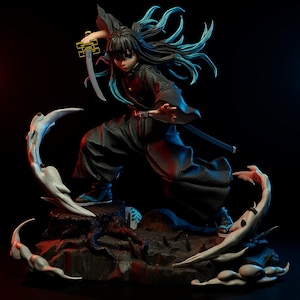 May include: A detailed figurine of a character in a dynamic pose, wielding a sword. The figure is dressed in black attire with a flowing cape and long, flowing hair with blue highlights. The base is a rocky terrain with white, stylized accents.