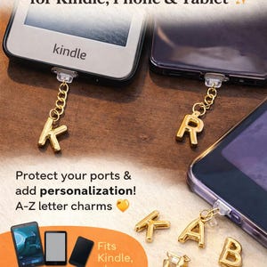May include: Gold-colored USB-C dust plug charms with A-Z letter designs. The charms are attached to a Kindle and a phone. The image also shows tablets and phones. The text reads: "Personalized USB-C Dust Plug Charms for Kindle, Phone & Tablet."