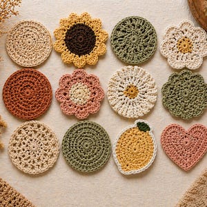 May include: A collection of handmade crochet coasters in various shapes and colors. Designs include sunflowers, daisies, and hearts, with colors like beige, orange, green, and pink. These decorative coasters are perfect for adding a touch of handmade charm to any home.