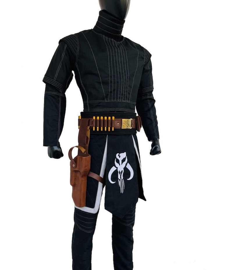 May include: Black costume with a high collar, featuring white stitching details. The outfit includes a brown belt with gold accents and a holster. A black and white graphic is on the lower garment. The costume is displayed on a mannequin.
