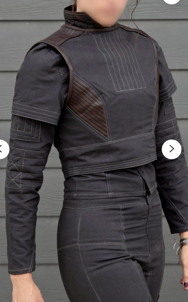 May include: Dark gray jacket and pants set with brown leather accents. The jacket features a high collar, shoulder pads, and decorative stitching. The pants are high-waisted and fitted. The outfit is made of a durable fabric, suitable for cosplay or fashion.