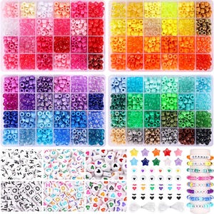 May include: A craft kit with a variety of colorful beads, including letter beads, heart-shaped beads, and star-shaped beads. The kit also includes bracelets with the words "ORANGE", "SMILE", "LOVE", "RAP", and "COOL".