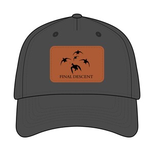 May include: A charcoal gray baseball cap with a curved brim. A rectangular patch features a silhouette of flying ducks in black against a brown background. The text "FINAL DESCENT" is below the ducks.