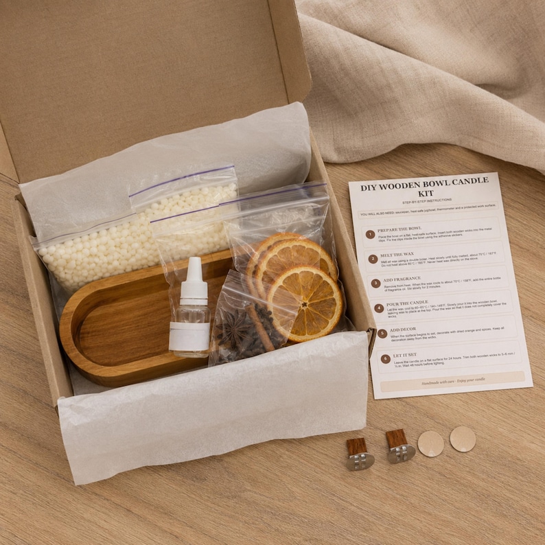 May include: A DIY wooden bowl candle kit in a cardboard box containing a wooden bowl, a bag of white wax beads, a small bottle of fragrance, dried orange slices, star anise, cinnamon sticks, two wicks, two wick tabs, and an instruction sheet.