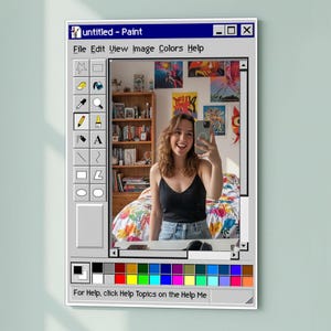 Op de afbeelding: Een ingelijst wandkunstwerk met een retro Windows Paint interface ontwerp. Het kunstwerk toont de titel "untitled - Paint", een kleurrijk palet en gereedschappen. De afbeelding in de lijst toont een persoon die een selfie maakt.