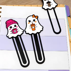 Three girl ghost 3D printed bookmarks displayed on planner pages, featuring pink, orange, and leopard print designs.