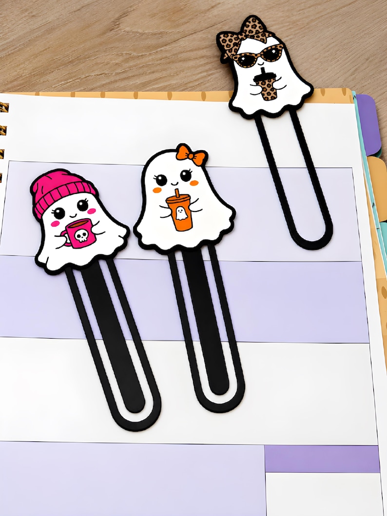 Three girl ghost 3D printed bookmarks displayed on planner pages, featuring pink, orange, and leopard print designs.