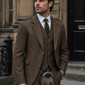 May include: A brown tweed suit, waistcoat, and tie. The suit has a two-button jacket and a traditional Scottish sporran. A white dress shirt completes the outfit. The suit is a classic style, suitable for formal occasions. The suit's fabric has a textured appearance.