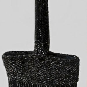 May include: A black handbag covered in small, reflective beads. The bag features a single upright handle and a body adorned with long, dangling beaded fringe that hangs from the bottom edge, creating a textured and shimmering appearance throughout.