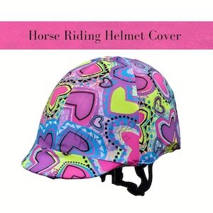 May include: A horse riding helmet cover featuring a colourful design of hearts and geometric shapes in pink, purple, blue, and green. The text "Horse Riding Helmet Cover" is displayed above the helmet.