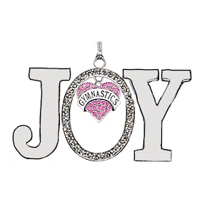 May include: A silver-colored pendant necklace spelling out the word "JOY". The letter "O" is a circle with a heart-shaped charm inside, reading "GYMNASTICS" in a pink and white design. The pendant is on a white background.