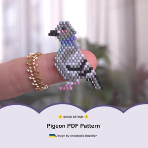 May include: A beaded pigeon figurine in shades of gray, black, and pink, perched on a finger. The bird is made with small beads, showcasing a detailed brick stitch pattern. The image also includes a gold beaded ring and text that reads "Pigeon PDF Pattern".